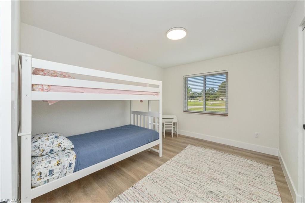 3560 Corana Way Naples, FL 34105 - Photo 20 of 24 a bedroom with bed and wall