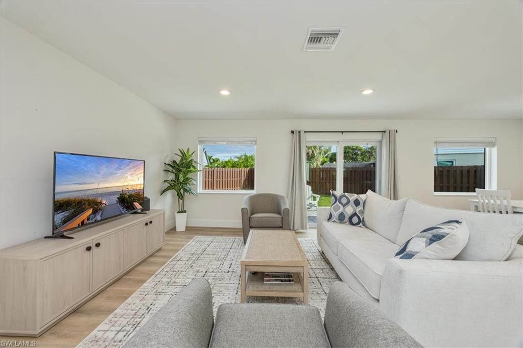 3560 Corana Way Naples, FL 34105 - Photo 3 of 24 a living room with furniture and a flat screen tv