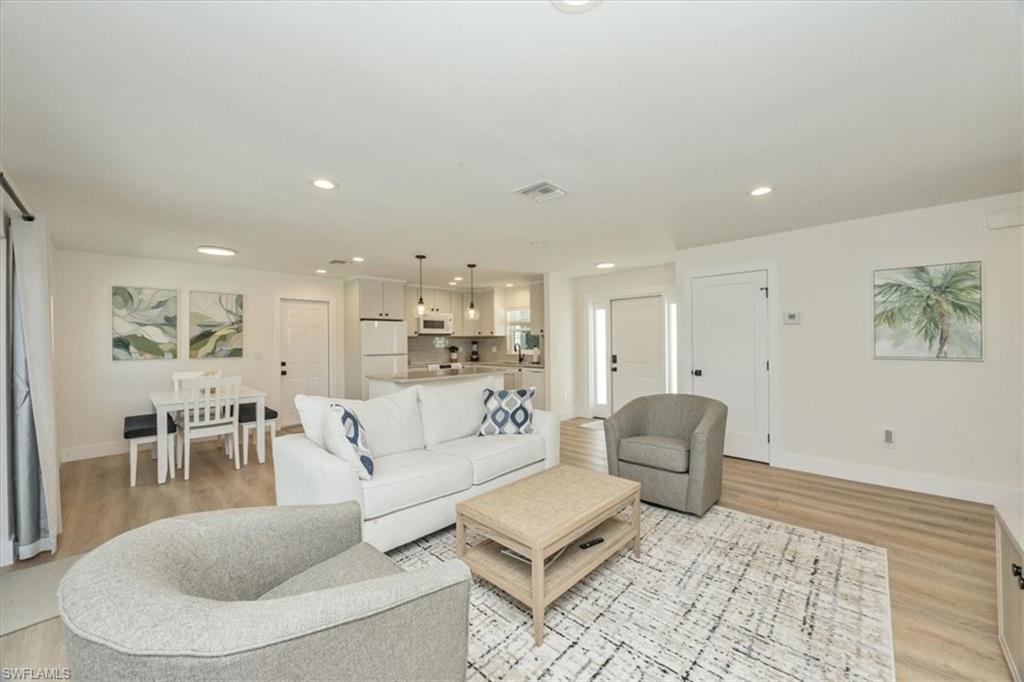 3560 Corana Way Naples, FL 34105 - Photo 4 of 24 a living room with furniture and a rug