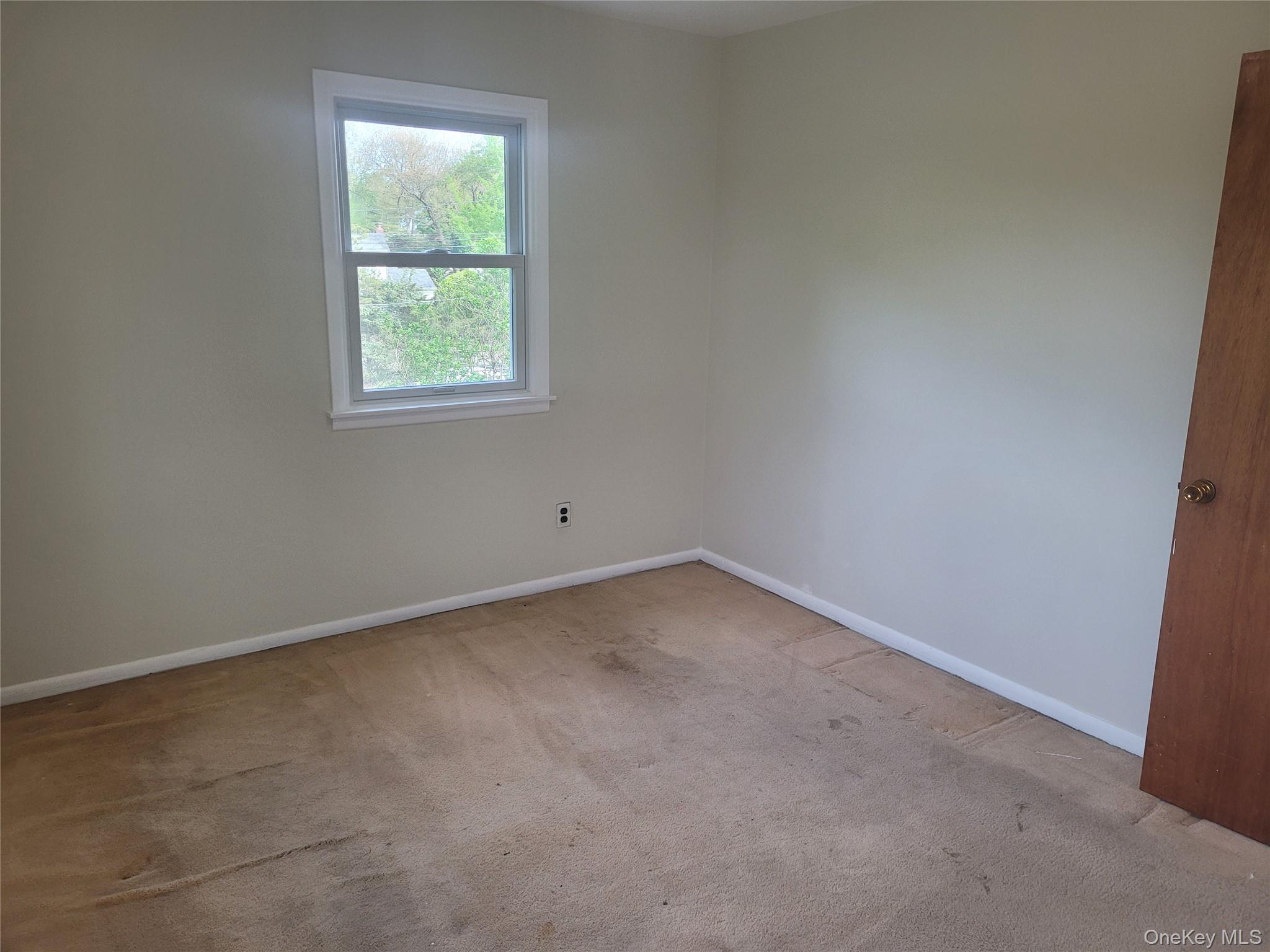 8 Cornell Road East Patchogue, NY 11772 - Photo 17 of 18 an empty room with a window