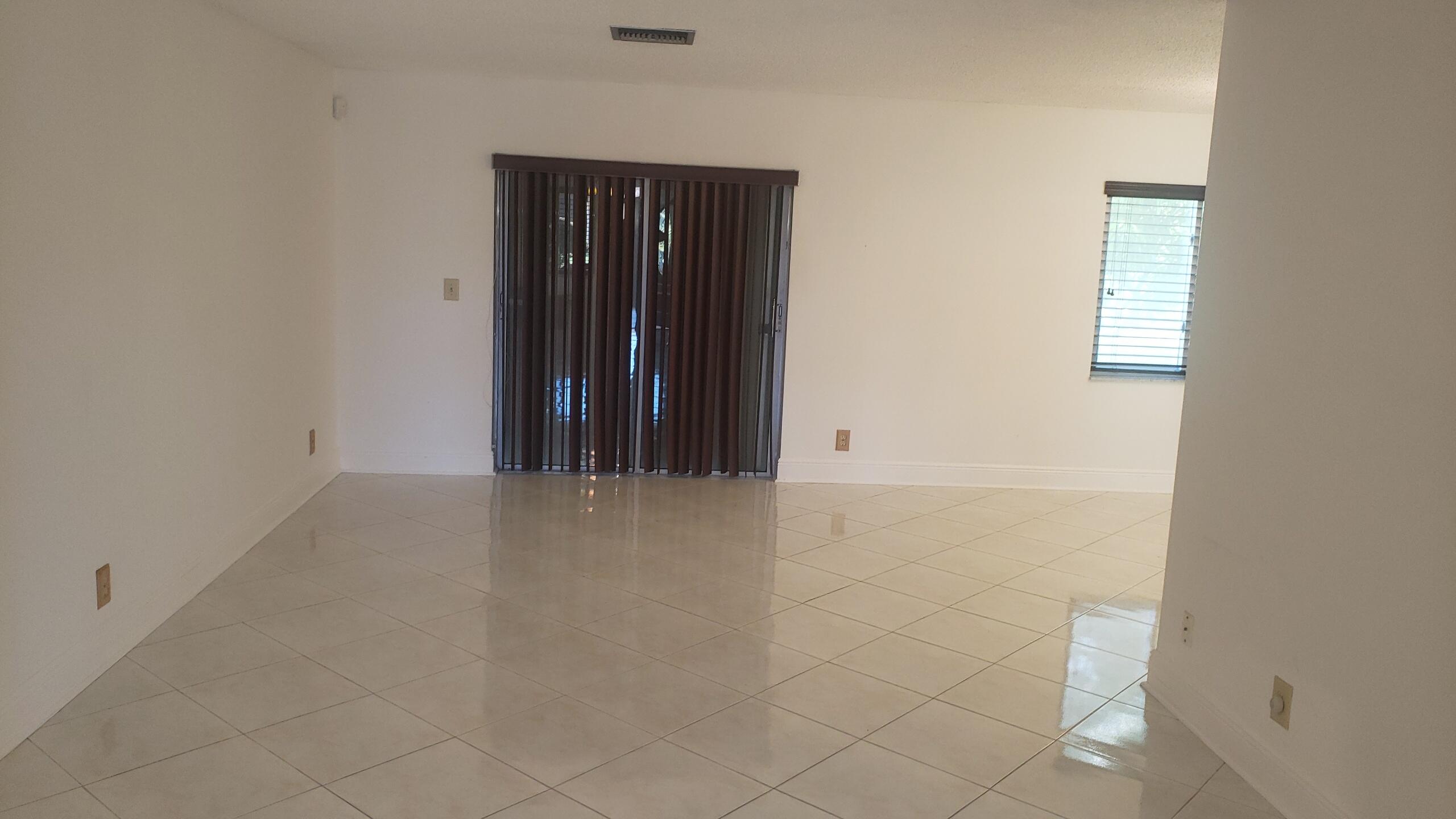 6085 Stanley Lane Delray Beach, FL 33484 - Photo 5 of 22 an empty room with an entryway