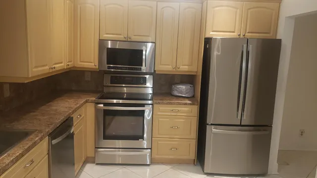 a kitchen with a refrigerator stove and microwave
