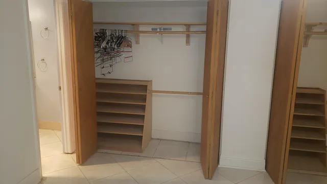 a view of walk in closet with empty racks