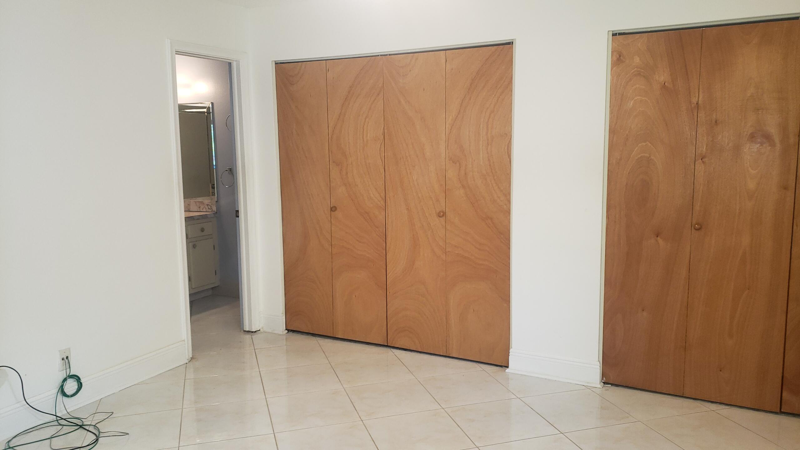 6085 Stanley Lane Delray Beach, FL 33484 - Photo 9 of 22 a view of an empty room with closet and mirror