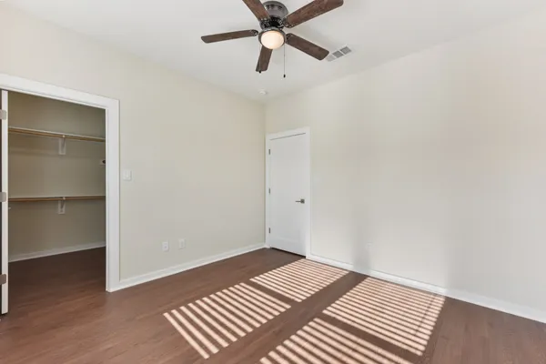a view of an empty room with a ceiling fan