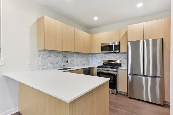 a kitchen with a refrigerator sink and microwave