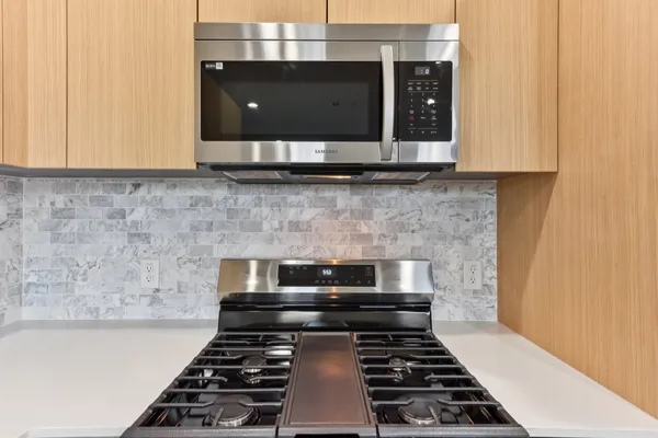 a kitchen with a stove and a microwave