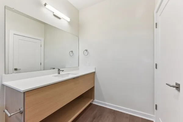 an empty room with ceiling fan and window