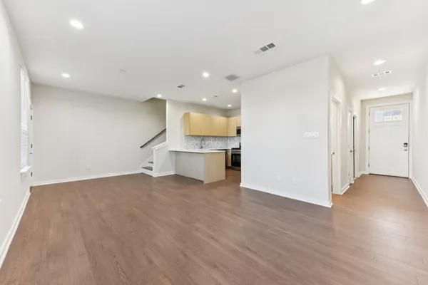 a view of a kitchen with a sink and a refrigerator