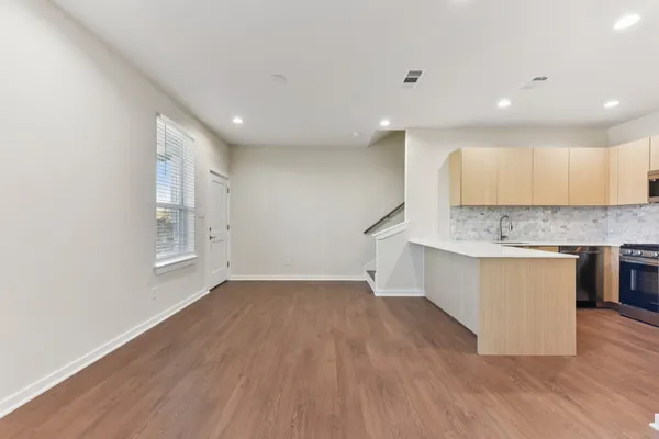 a view of kitchen with granite countertop cabinets and wooden floor