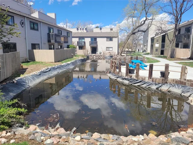a view of a house with a yard and furniture