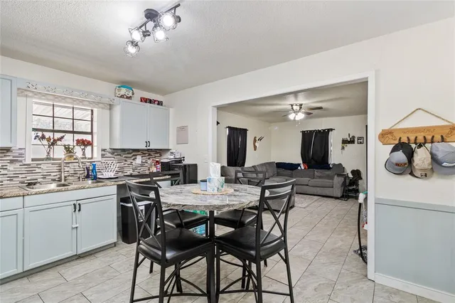 a view of a dining room with furniture and a chandelier