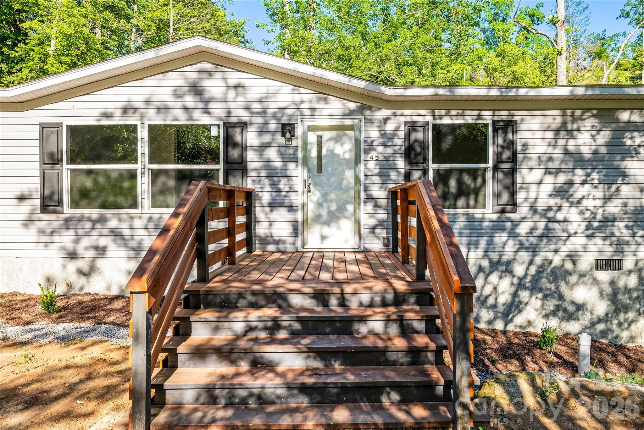 45 Alan Retreat Road Hendersonville, NC 28792 - Photo 8 of 25 a view of a balcony with floor to ceiling window and wooden fence