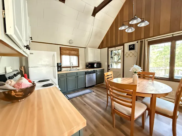 a kitchen with a table chairs stove and cabinets