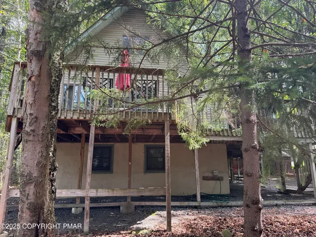 a view of a house with a tree
