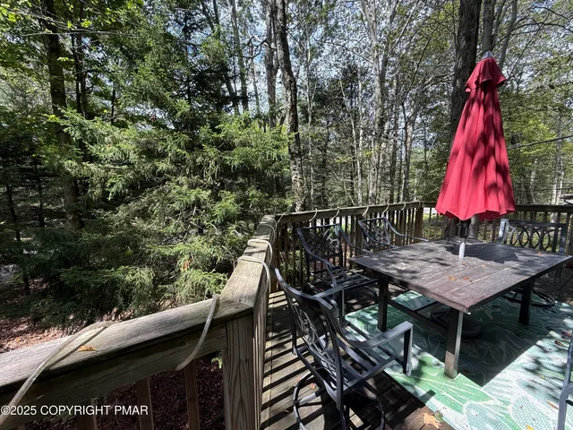 a view of a wooden deck with furniture