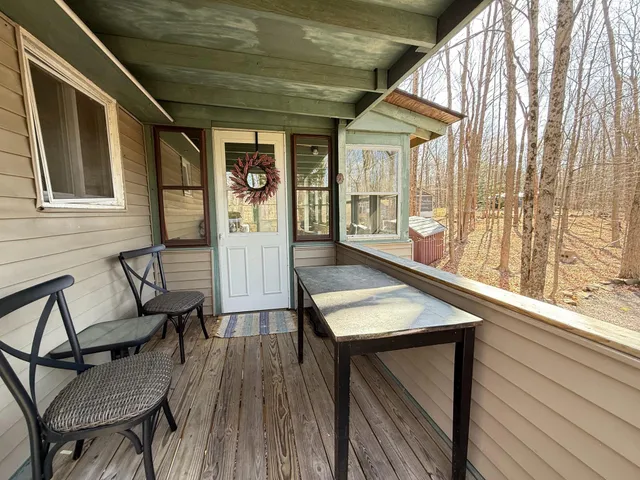 a roof deck with couch and chairs