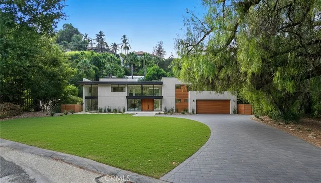 a view of a house with a yard and a patio