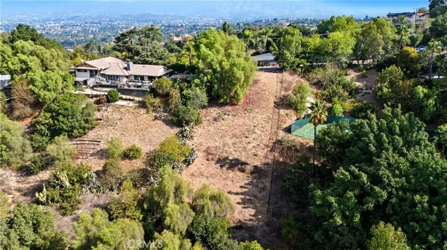 an aerial view of a houses with a yard