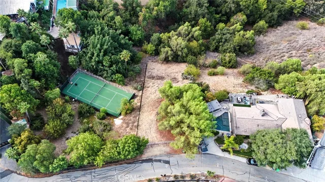an aerial view of a house with a yard and outdoor seating