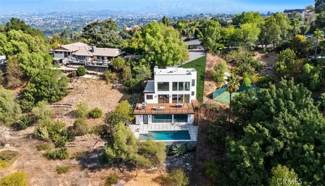 an aerial view of a house with a yard swimming pool and mountain view