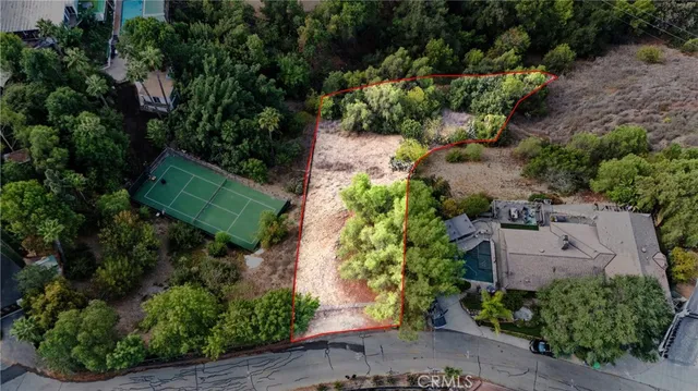 an aerial view of residential house with green space