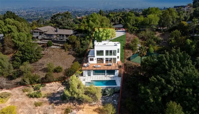 an aerial view of a house with a yard