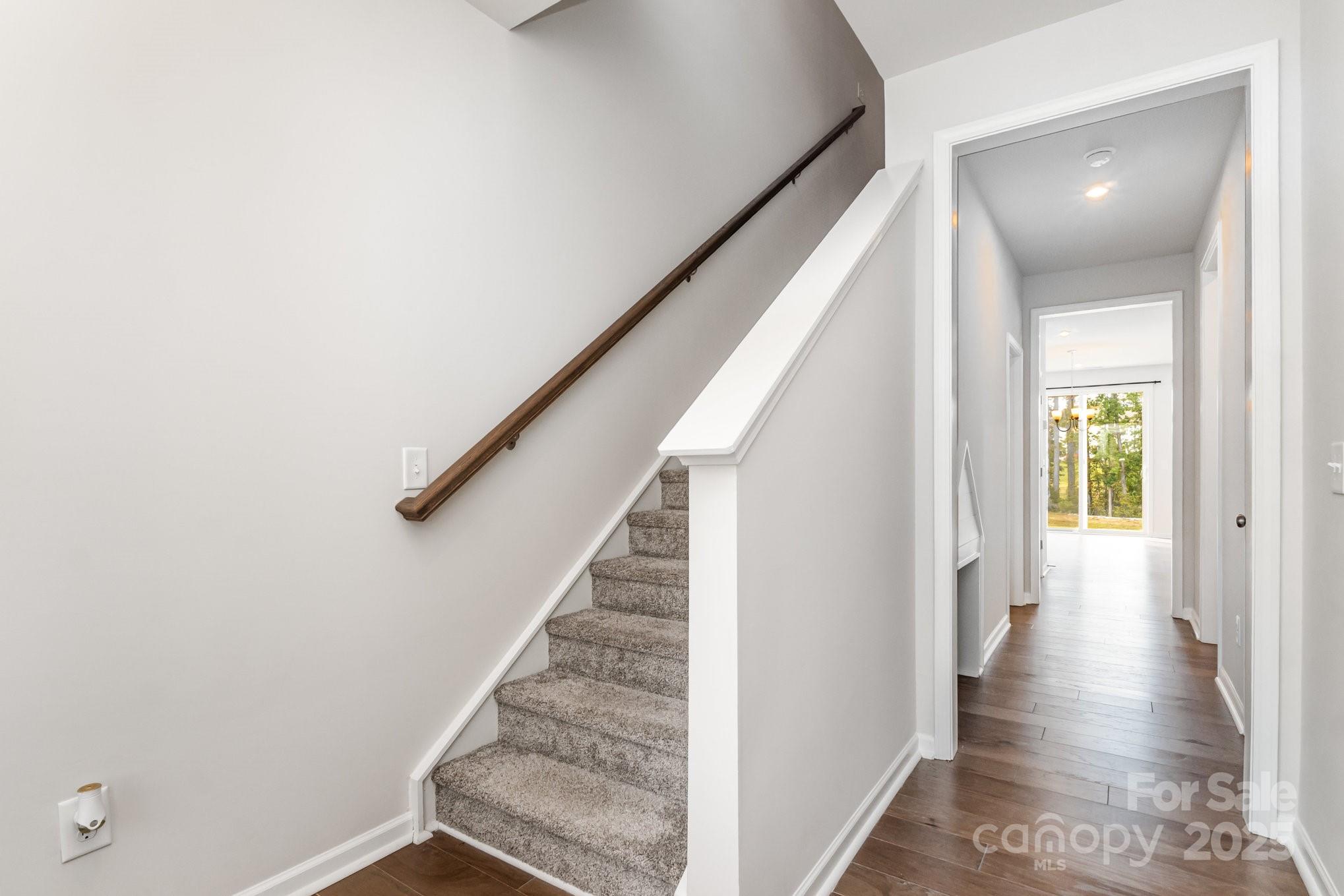 9029 Widden Way Charlotte, NC 28269 - Photo 13 of 29 a view of a hallway with wooden floor and staircase