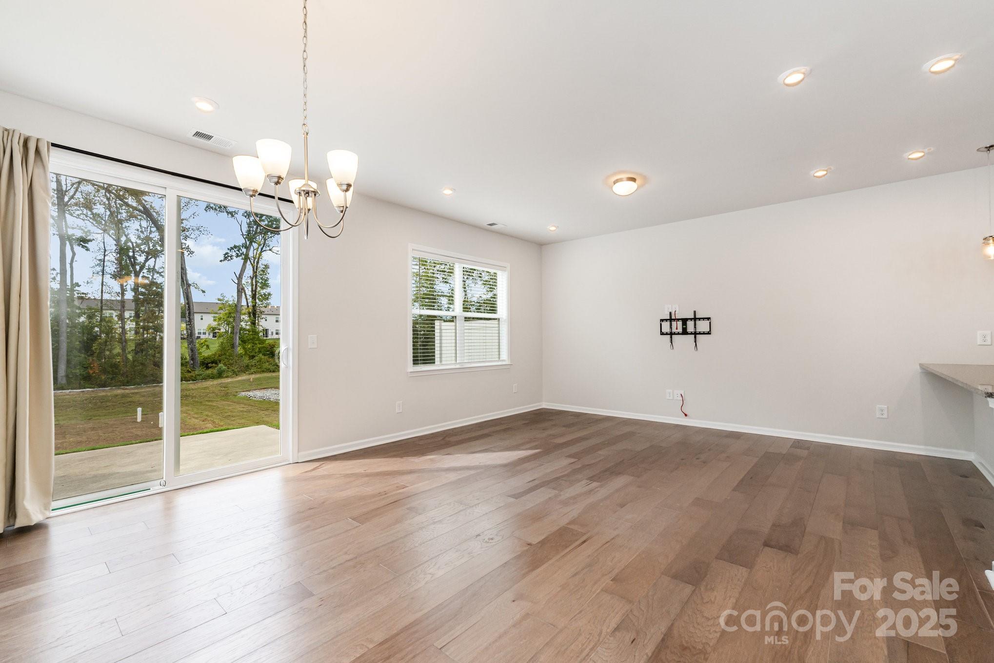 9029 Widden Way Charlotte, NC 28269 - Photo 15 of 29 a view of an empty room with wooden floor and a window
