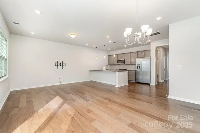a view of a kitchen with marble kitchen and stainless steel appliances