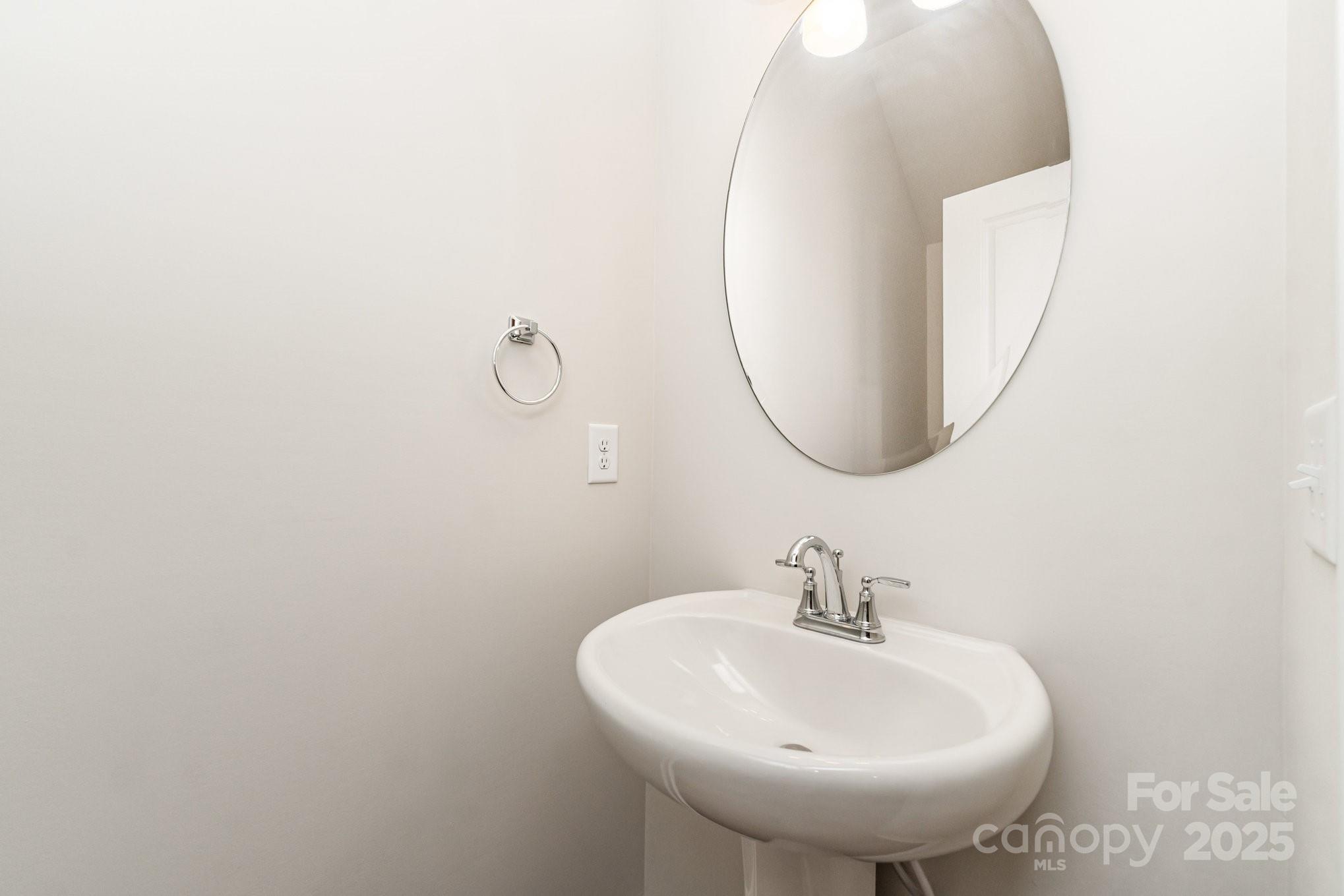 9029 Widden Way Charlotte, NC 28269 - Photo 17 of 29 a bathroom with a sink and a mirror