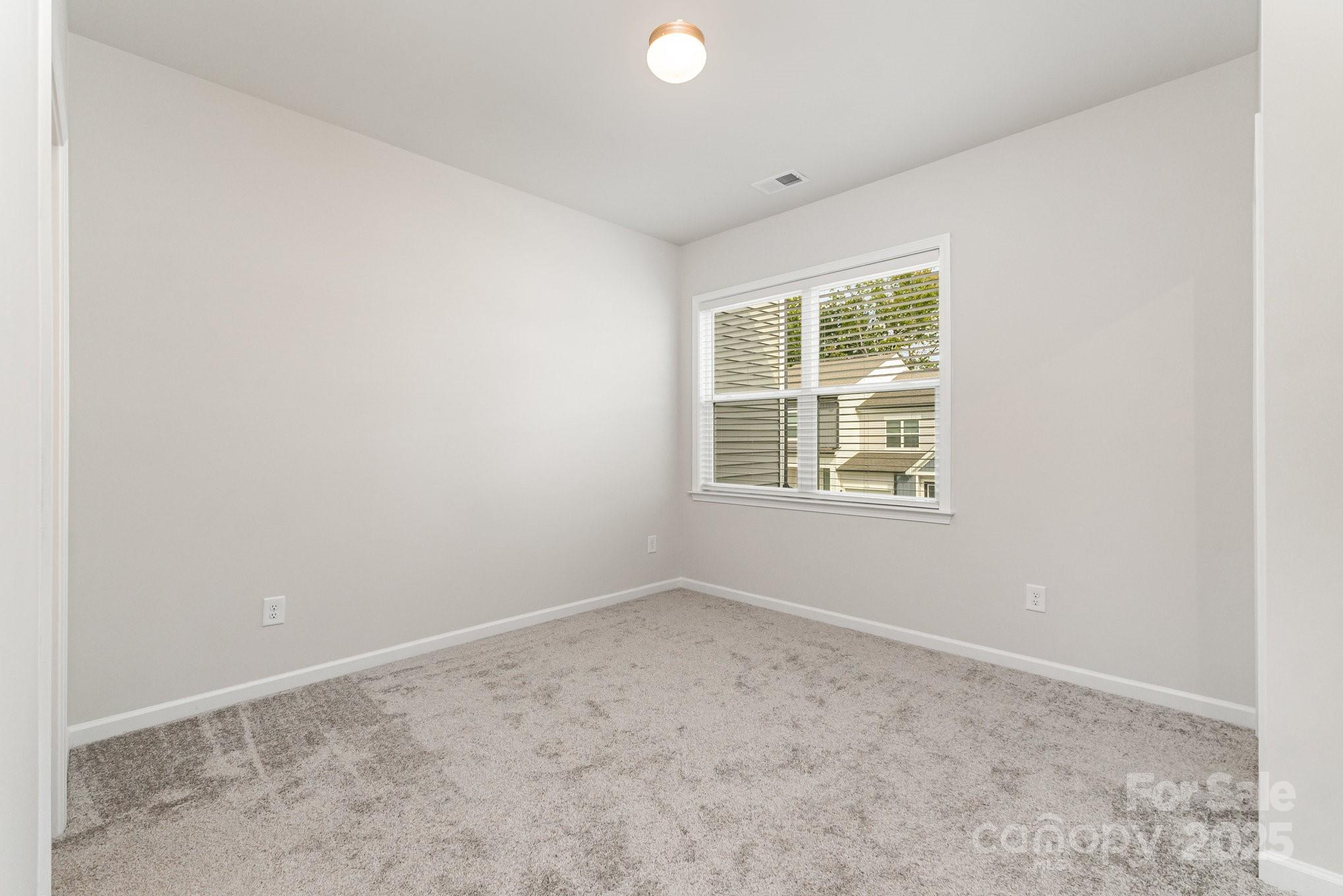 9029 Widden Way Charlotte, NC 28269 - Photo 22 of 29 an empty room with windows