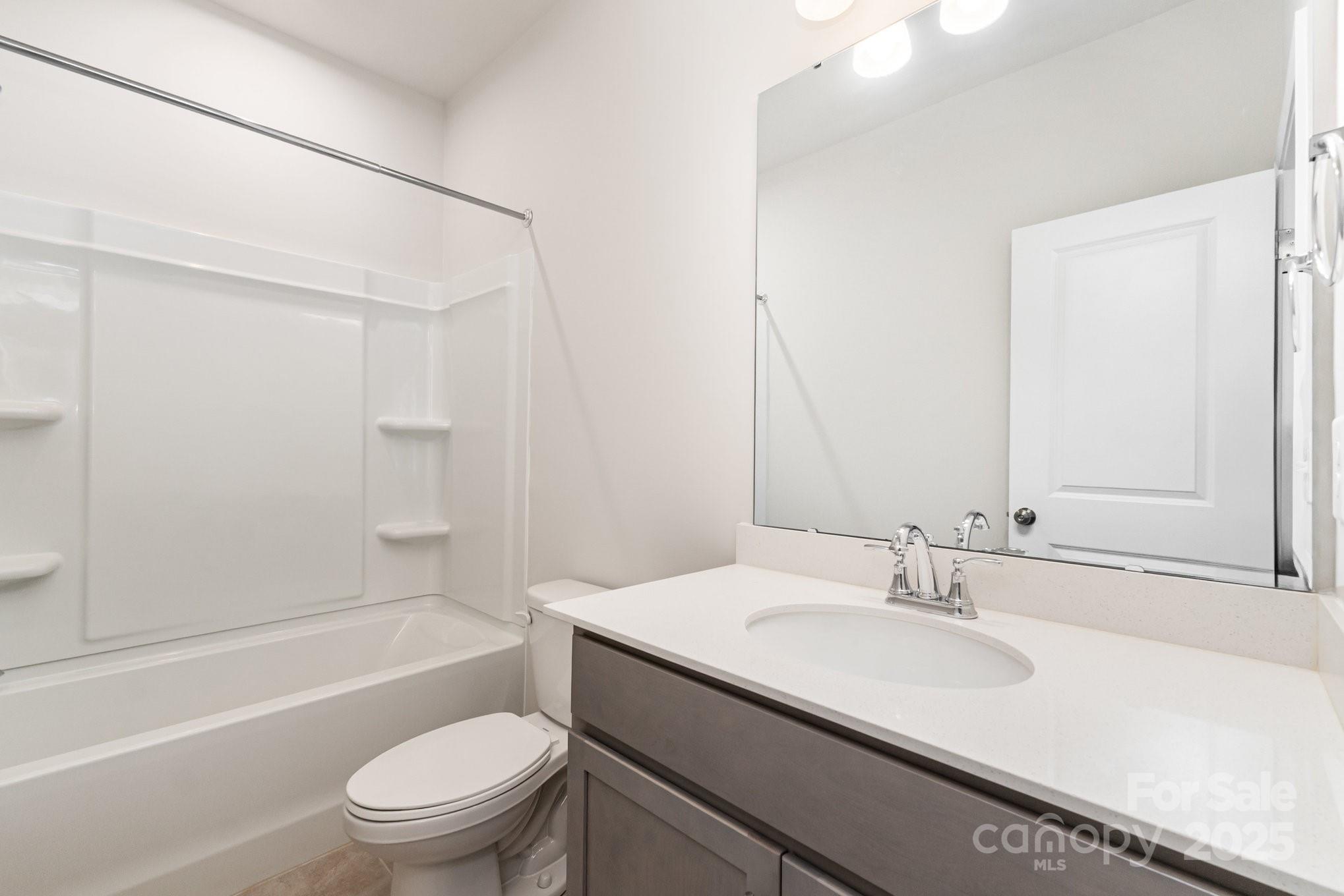 9029 Widden Way Charlotte, NC 28269 - Photo 24 of 29 a bathroom with a granite countertop sink toilet and shower