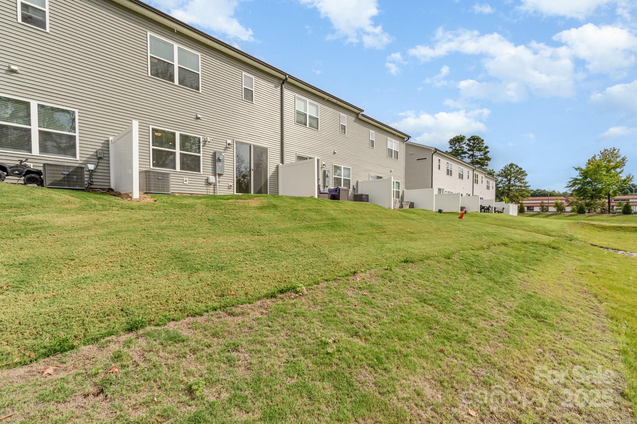 9029 Widden Way Charlotte, NC 28269 - Photo 27 of 29 a view of a house with a yard and garage