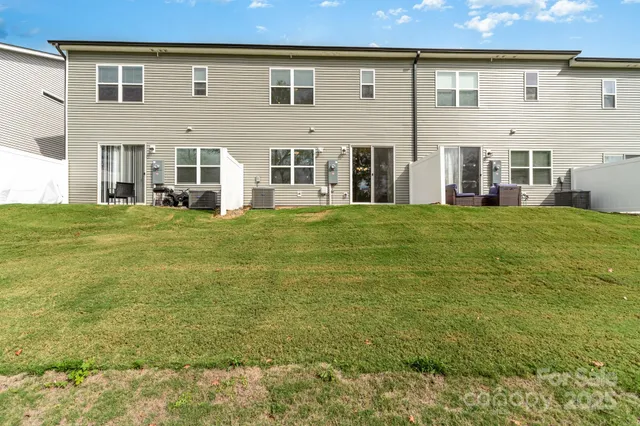 front view of a brick house with a yard