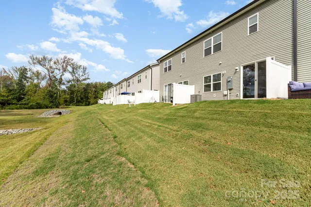 a big white house with a big yard and large trees