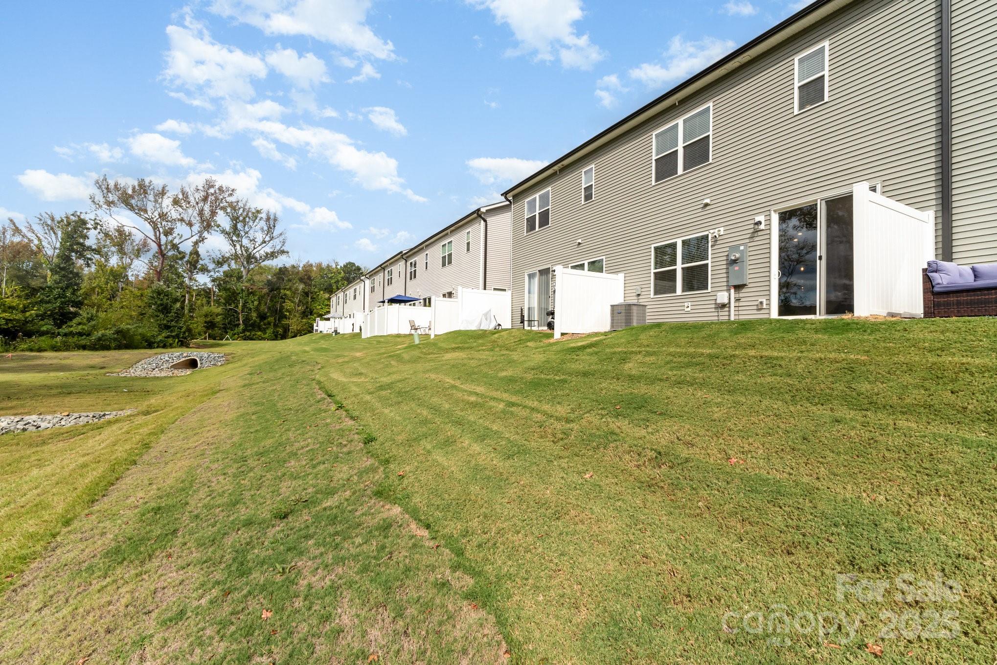 9029 Widden Way Charlotte, NC 28269 - Photo 29 of 29 a big white house with a big yard and large trees