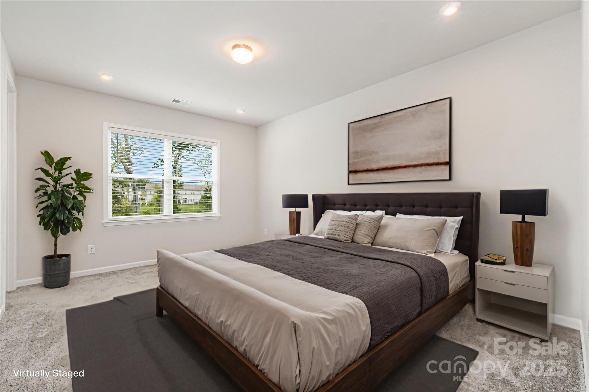 9029 Widden Way Charlotte, NC 28269 - Photo 10 of 29 a bedroom with bed and a potted plant