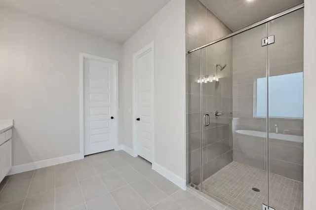 a bathroom that has a glass shower door
