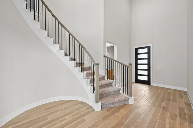 a view of a hallway with wooden floor and entryway