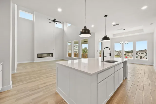 a kitchen with kitchen island a sink appliances and a counter top space
