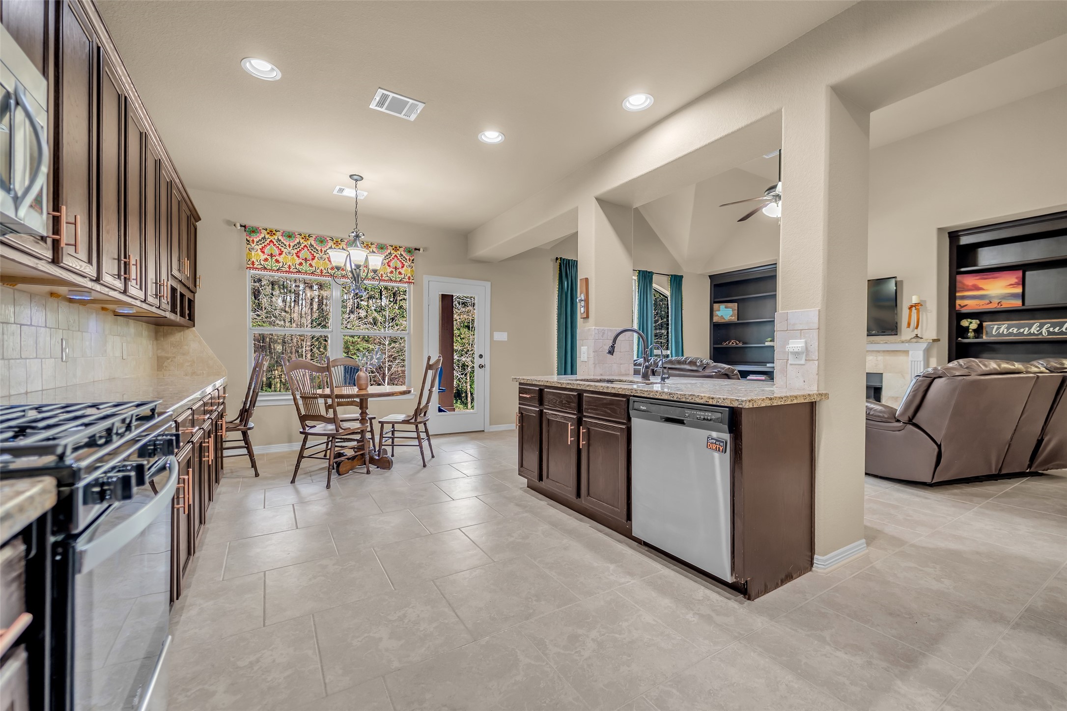 14752 Highland Ranch Drive Montgomery, TX 77316 - Photo 19 of 39 a kitchen with sink and chairs