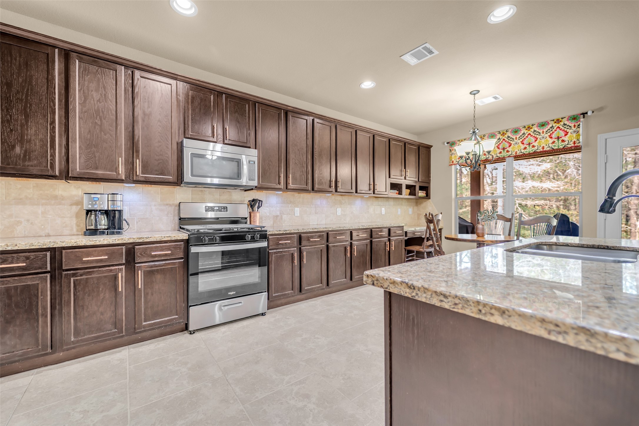 14752 Highland Ranch Drive Montgomery, TX 77316 - Photo 20 of 39 a kitchen with stainless steel appliances granite countertop a stove sink and cabinets