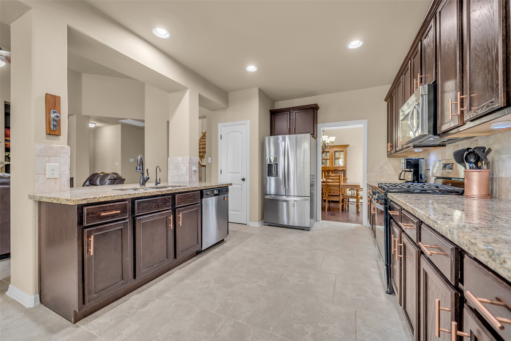 14752 Highland Ranch Drive Montgomery, TX 77316 - Photo 21 of 39 a large kitchen with stainless steel appliances granite countertop a lot of counter space and wooden floor