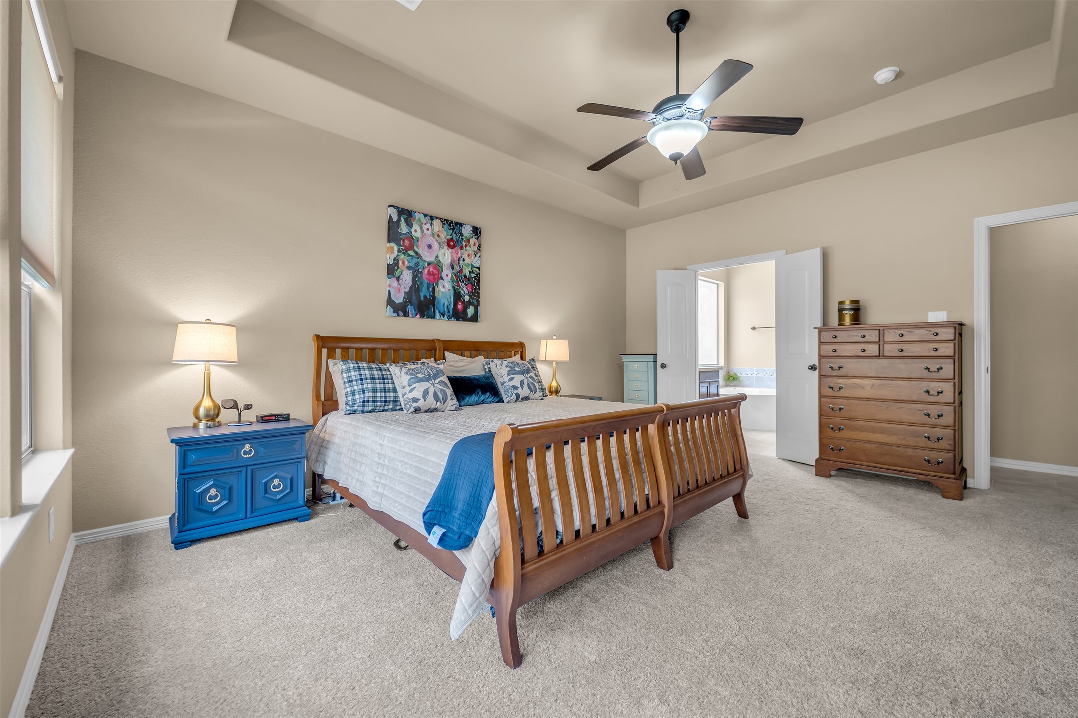 14752 Highland Ranch Drive Montgomery, TX 77316 - Photo 24 of 39 a spacious bedroom with a bed and a chandelier