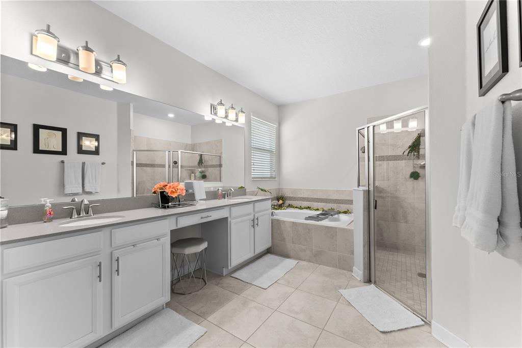 2926 Wordsmith Road Kissimmee, FL 34746 - Photo 32 of 42 a bathroom with a double vanity sink mirror and shower
