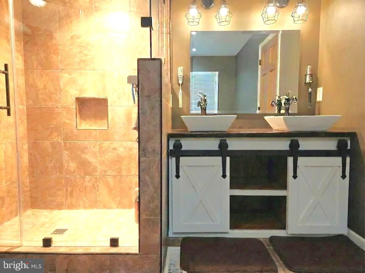 5632 Galestown - Reliance Road Rhodesdale, MD 21659 - Photo 18 of 25 a bathroom with a sink and a mirror