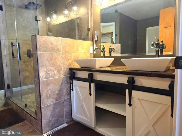 a bathroom with a toilet a sink and a mirror