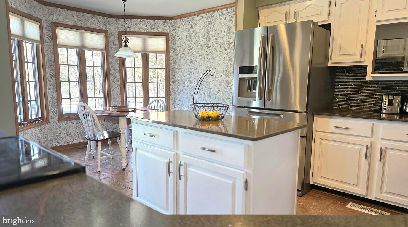5632 Galestown - Reliance Road Rhodesdale, MD 21659 - Photo 10 of 25 a kitchen with stainless steel appliances granite countertop a refrigerator a stove and a sink with granite countertops