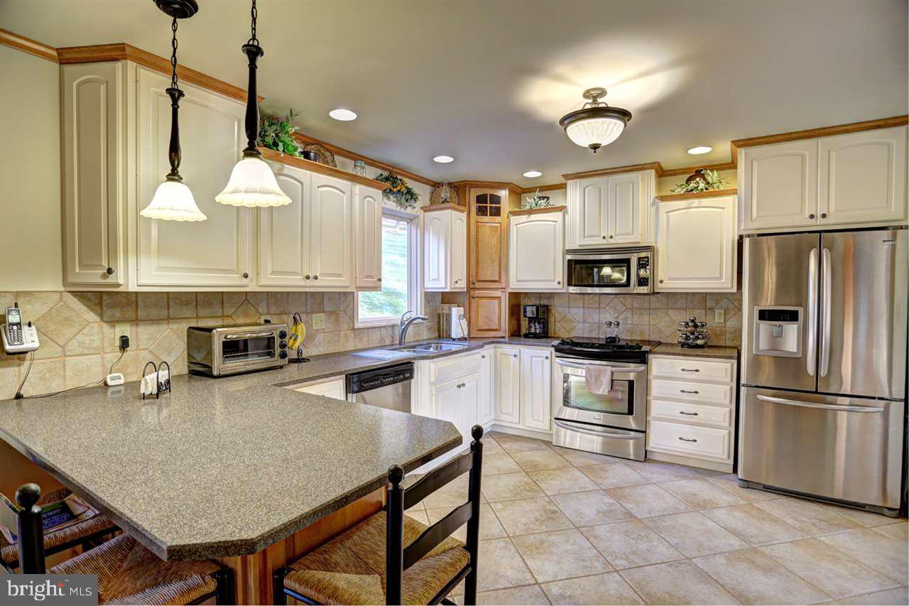 5 Rettinger Road Halifax, PA 17032 - Photo 10 of 25 a kitchen with a refrigerator a stove a sink dishwasher and a refrigerator with wooden floor